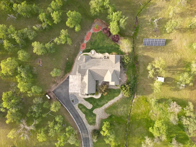 a view of a lush green hillside and houses