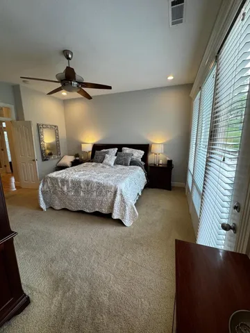 a bedroom with a bed and a television