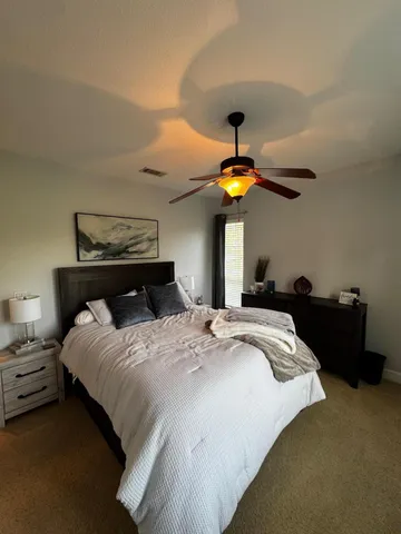 a view of a grassy field with trees