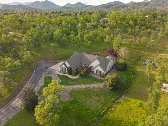 an aerial view of residential houses with outdoor space