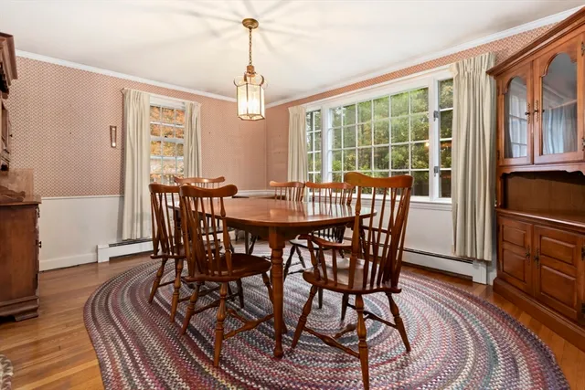 a view of a dining room with furniture window and wooden floor