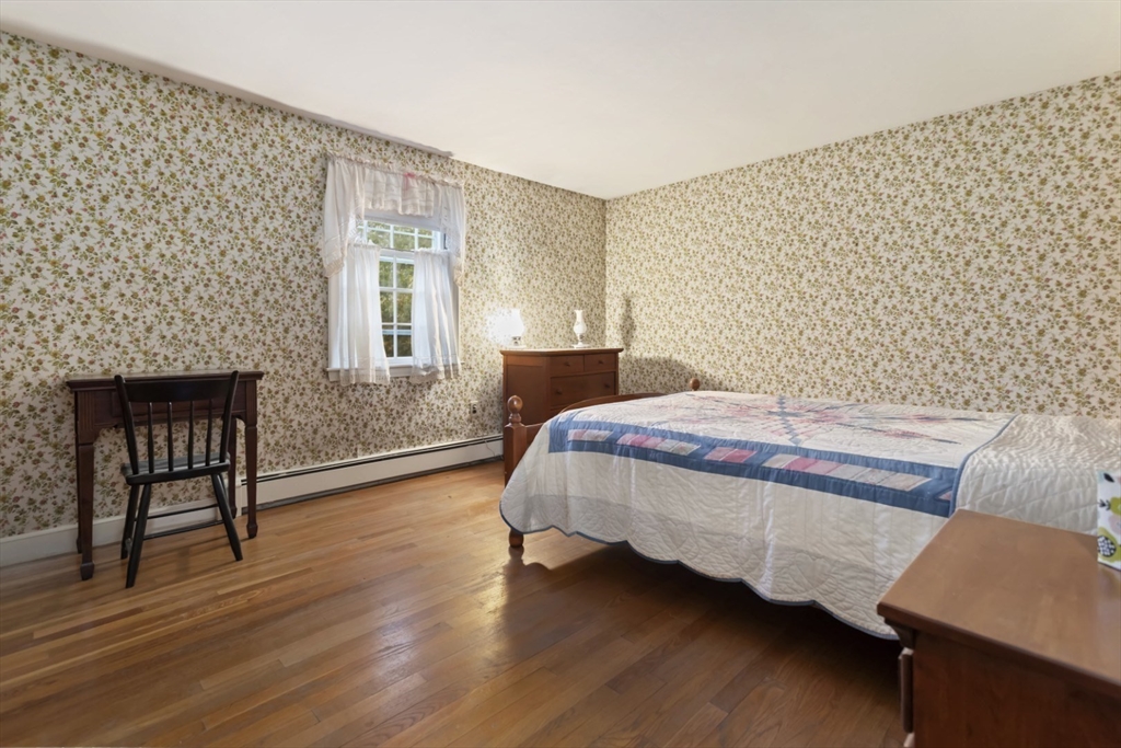 33 Wing Road Lynnfield, MA 01940 - Photo 17 of 29 a bedroom with a bed chair and a window