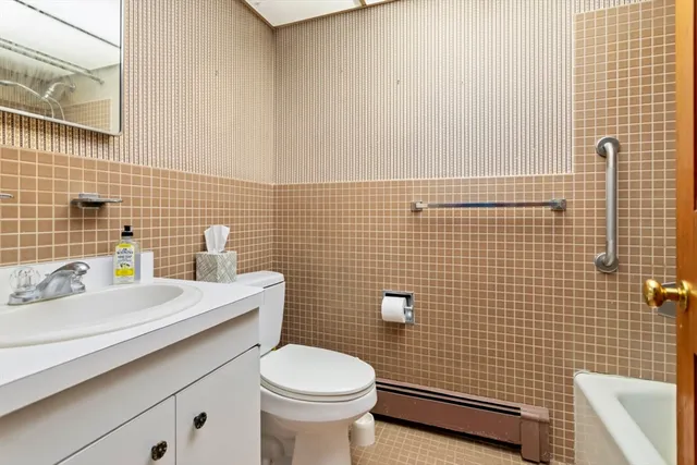 a bathroom with a sink a toilet and a mirror