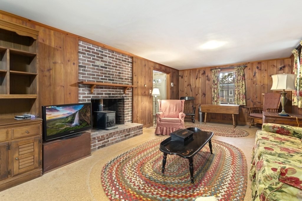 33 Wing Road Lynnfield, MA 01940 - Photo 6 of 29 a living room with furniture and a fireplace