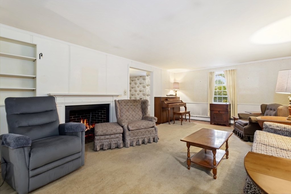 33 Wing Road Lynnfield, MA 01940 - Photo 10 of 29 a living room with furniture and a fireplace