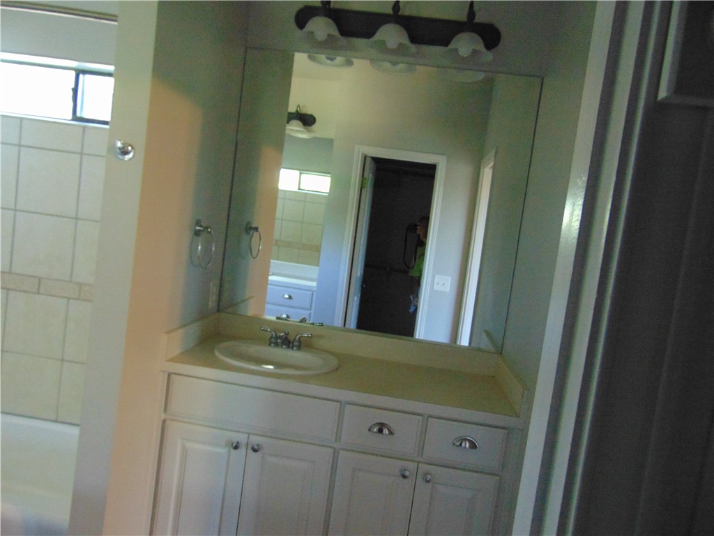 Undisclosed Address Dripping Springs, TX 78620 - Photo 11 of 14 a bathroom with a granite countertop sink a mirror and shower