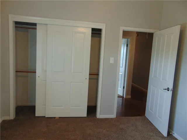 a view of kitchen with granite countertop cabinets and sink