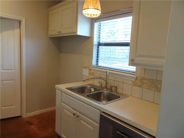 a kitchen with a sink and a window