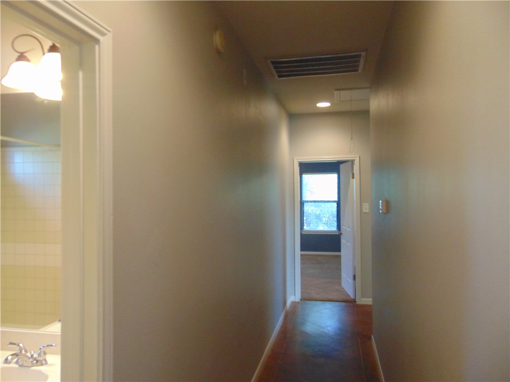 Undisclosed Address Dripping Springs, TX 78620 - Photo 6 of 14 a view of a hallway with wooden floor