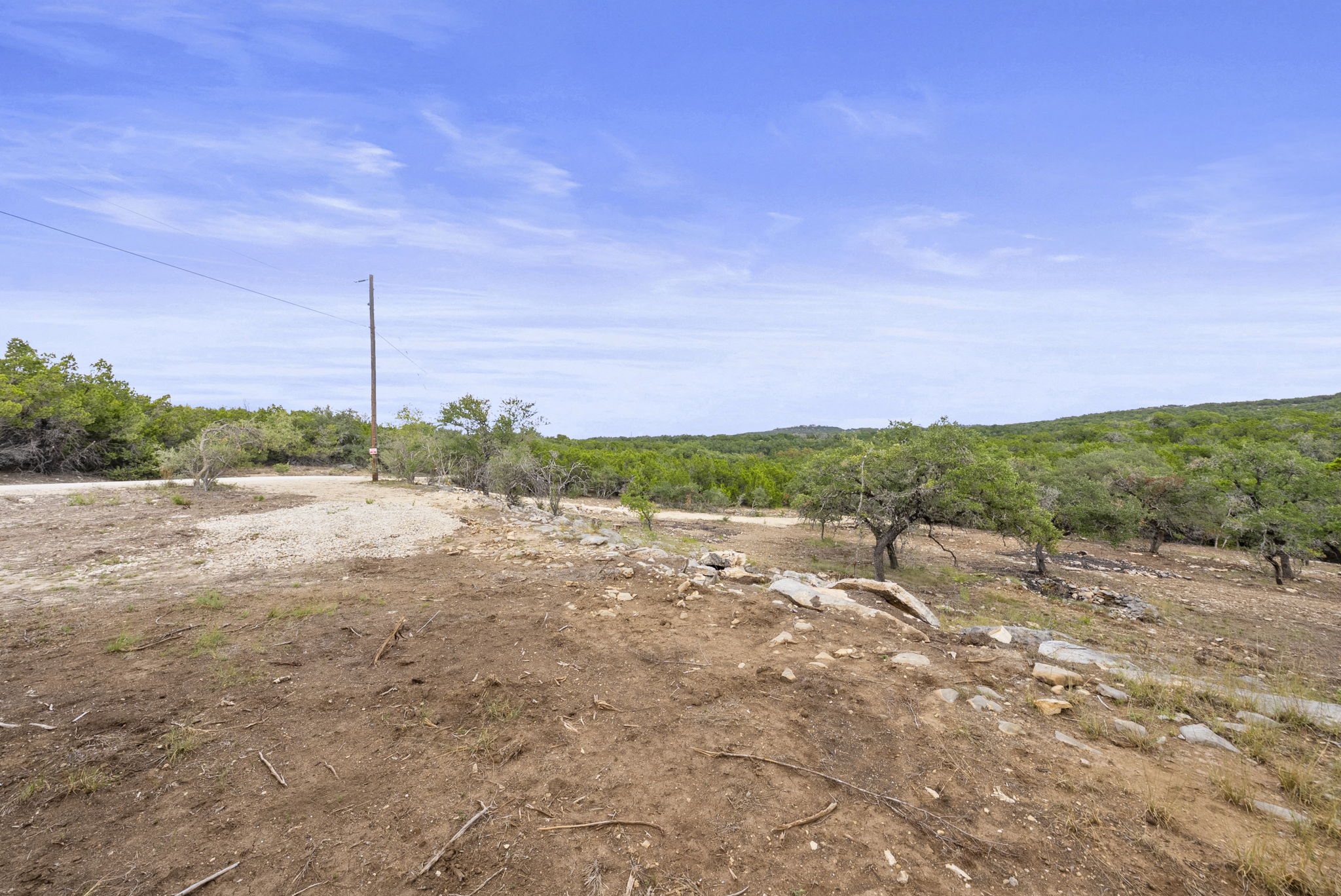 1250 Myers Creek Road Dripping Springs, TX 78620 - Photo 13 of 34 Recent improvements include a new cut entry drive, a wide clearing for a potential home site, and the removal of a natural dam in the dry creek bed.