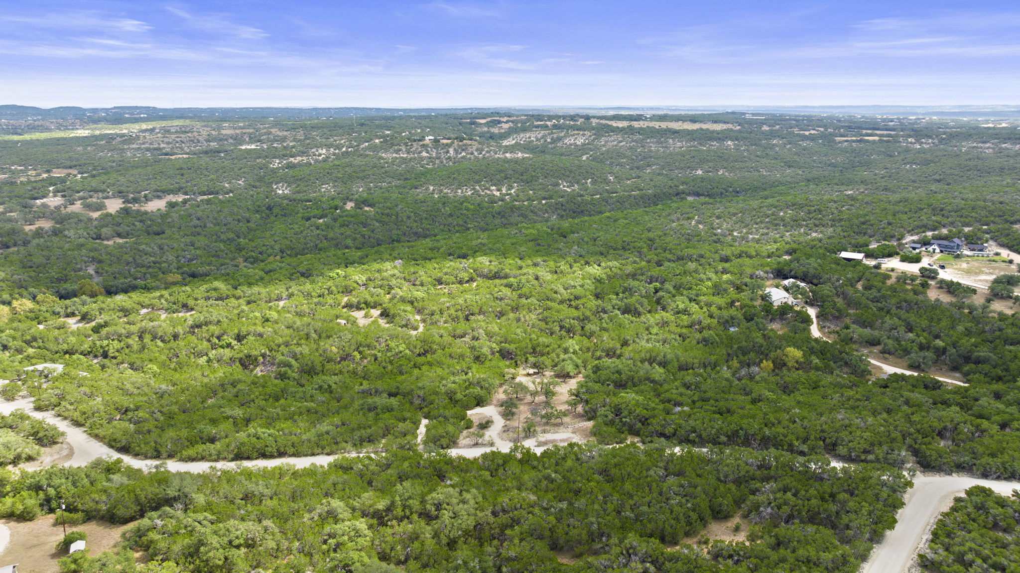 1250 Myers Creek Road Dripping Springs, TX 78620 - Photo 16 of 34 Recent improvements include a new cut entry drive, a wide clearing for a potential home site, and the removal of a natural dam in the dry creek bed.