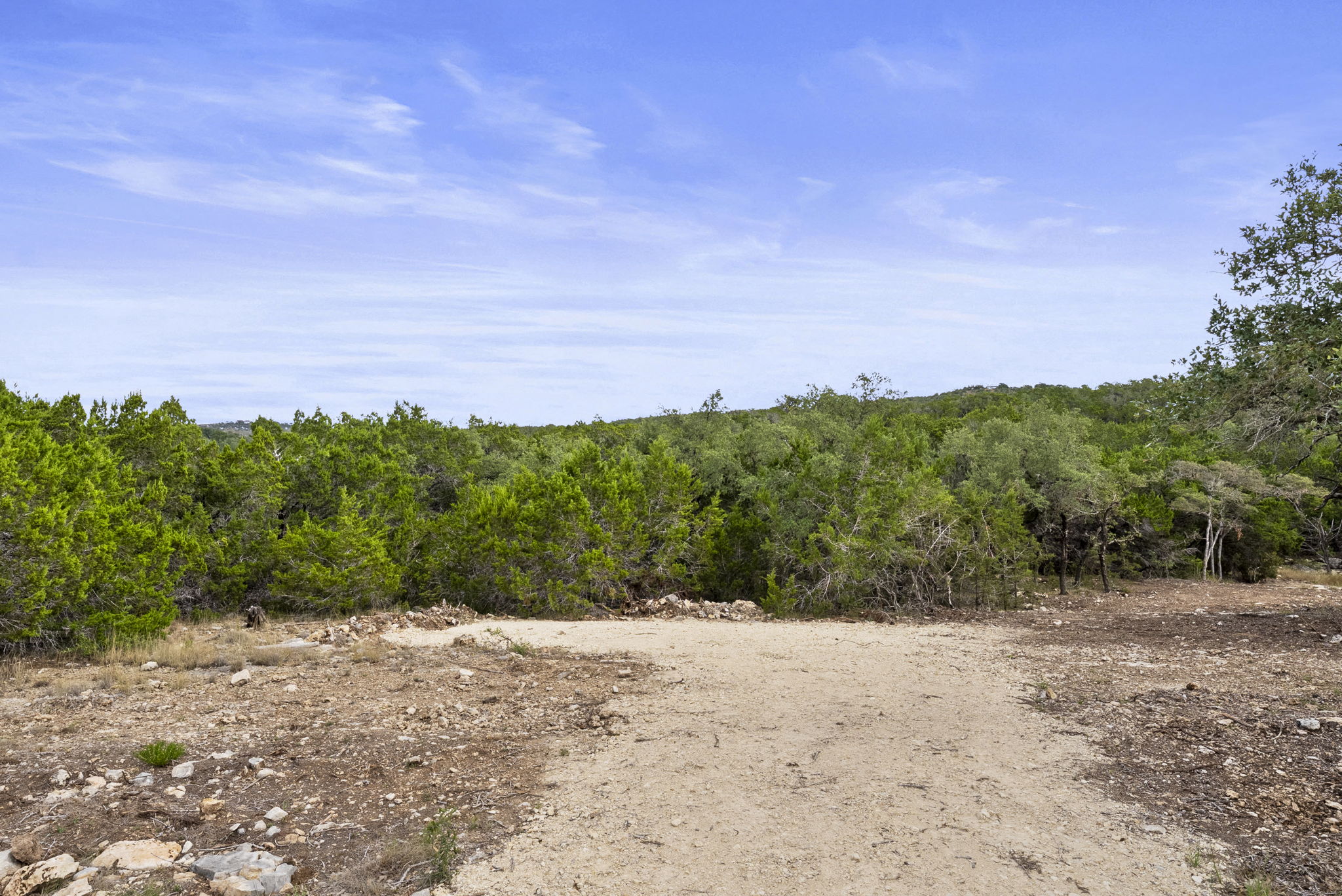 1250 Myers Creek Road Dripping Springs, TX 78620 - Photo 18 of 34 Recent improvements include a new cut entry drive, a wide clearing for a potential home site, and the removal of a natural dam in the dry creek bed.