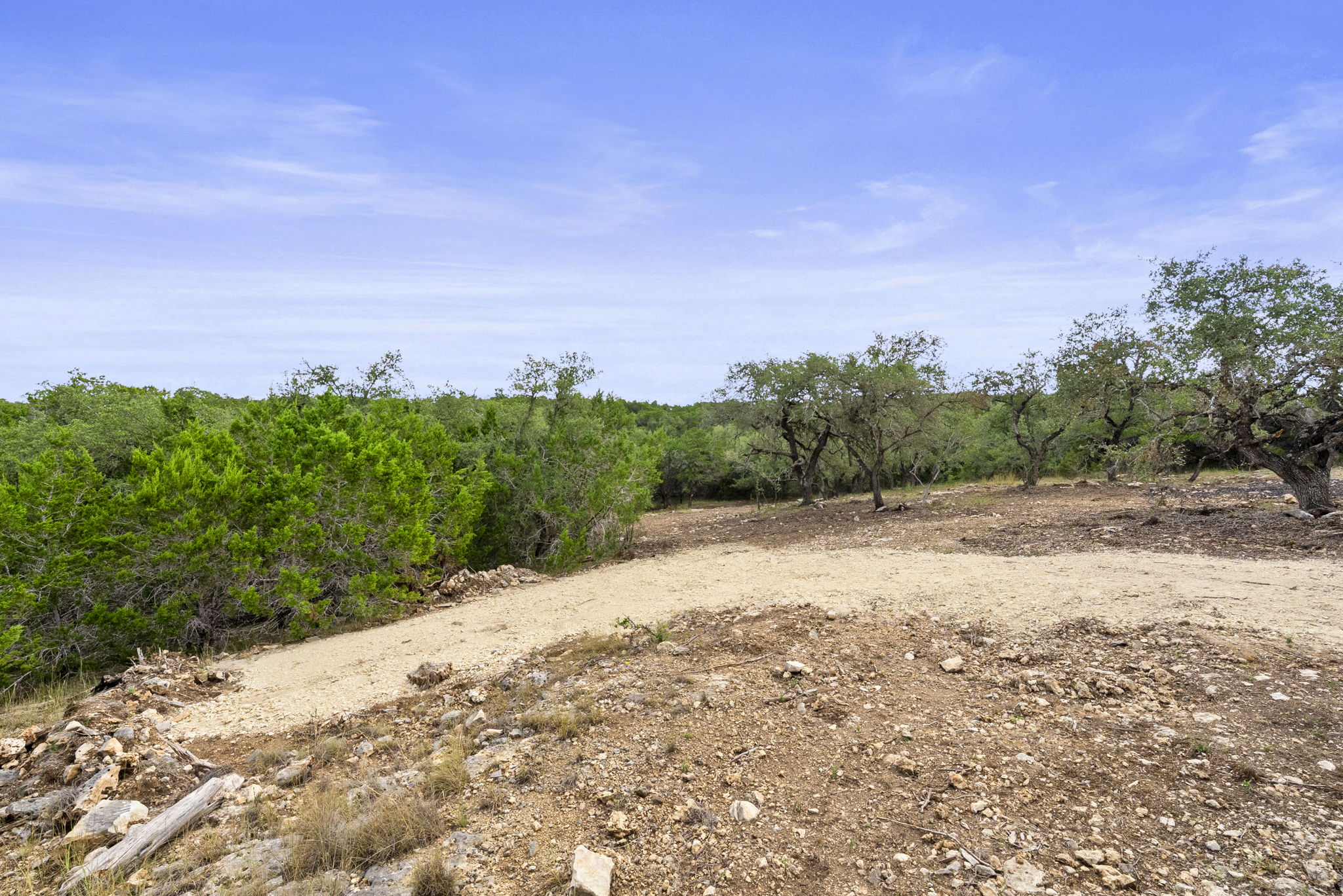 1250 Myers Creek Road Dripping Springs, TX 78620 - Photo 24 of 34 Recent improvements include a new cut entry drive, a wide clearing for a potential home site, and the removal of a natural dam in the dry creek bed.