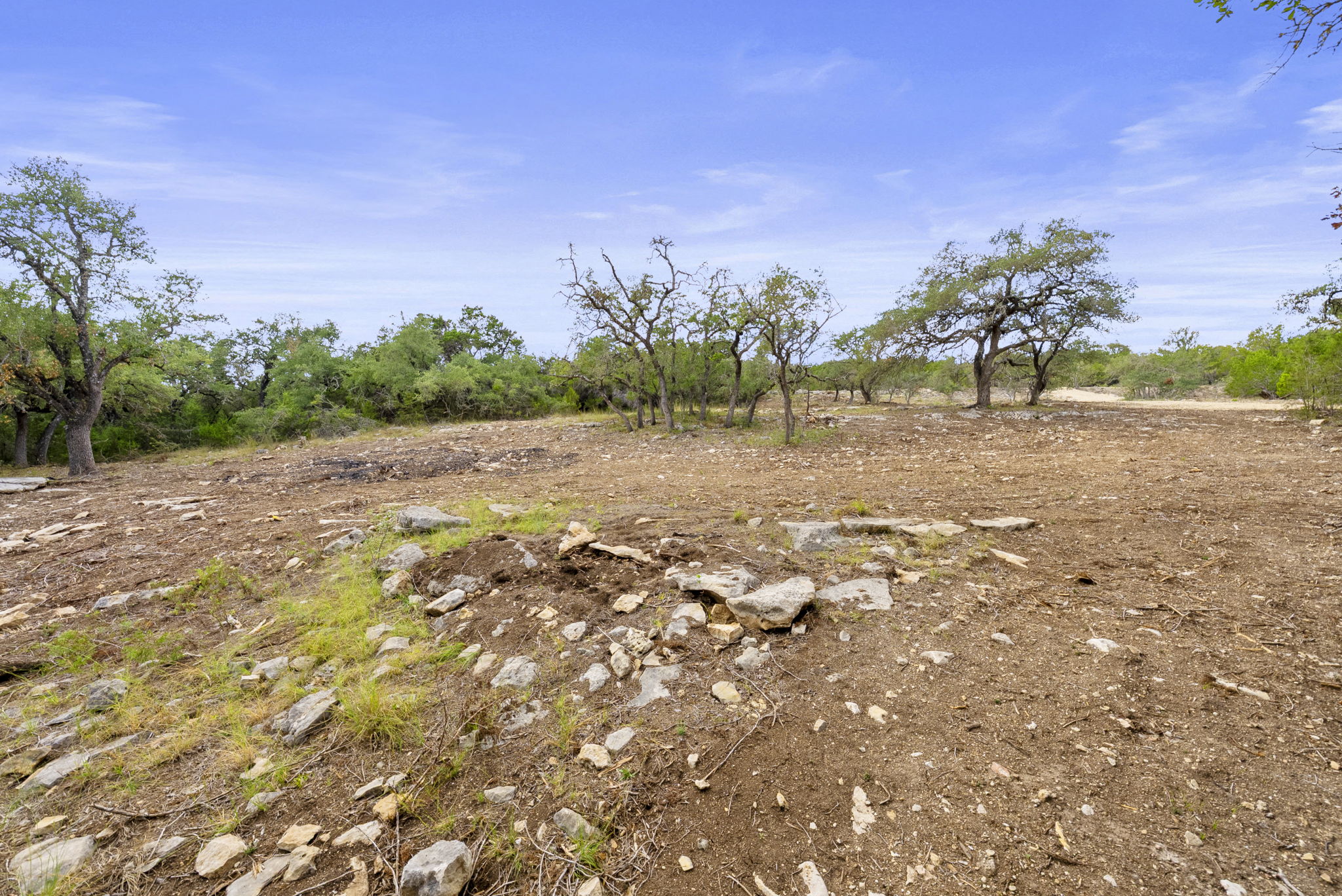 1250 Myers Creek Road Dripping Springs, TX 78620 - Photo 31 of 34 Recent improvements include a new cut entry drive, a wide clearing for a potential home site, and the removal of a natural dam in the dry creek bed.