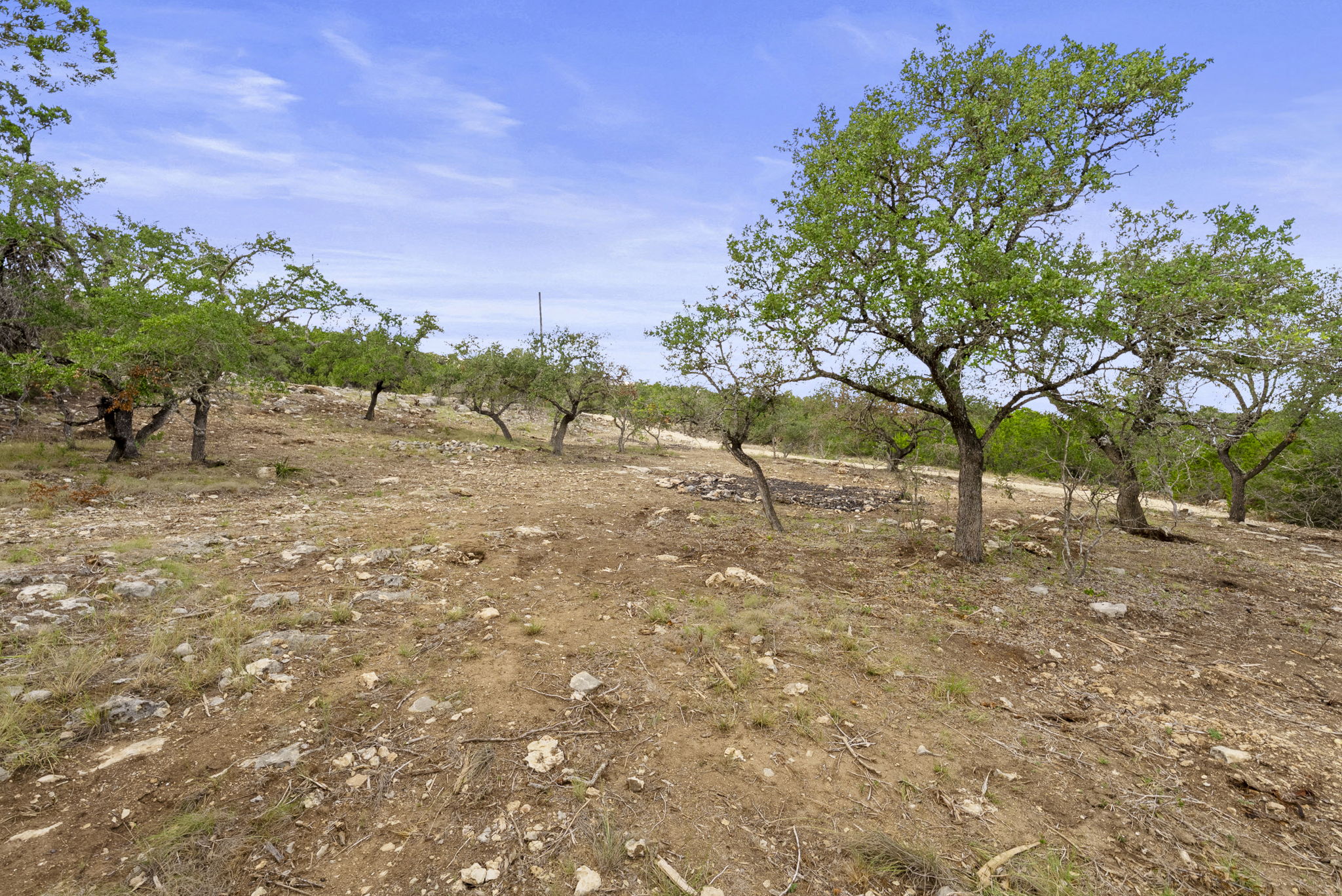 1250 Myers Creek Road Dripping Springs, TX 78620 - Photo 32 of 34 Recent improvements include a new cut entry drive, a wide clearing for a potential home site, and the removal of a natural dam in the dry creek bed.