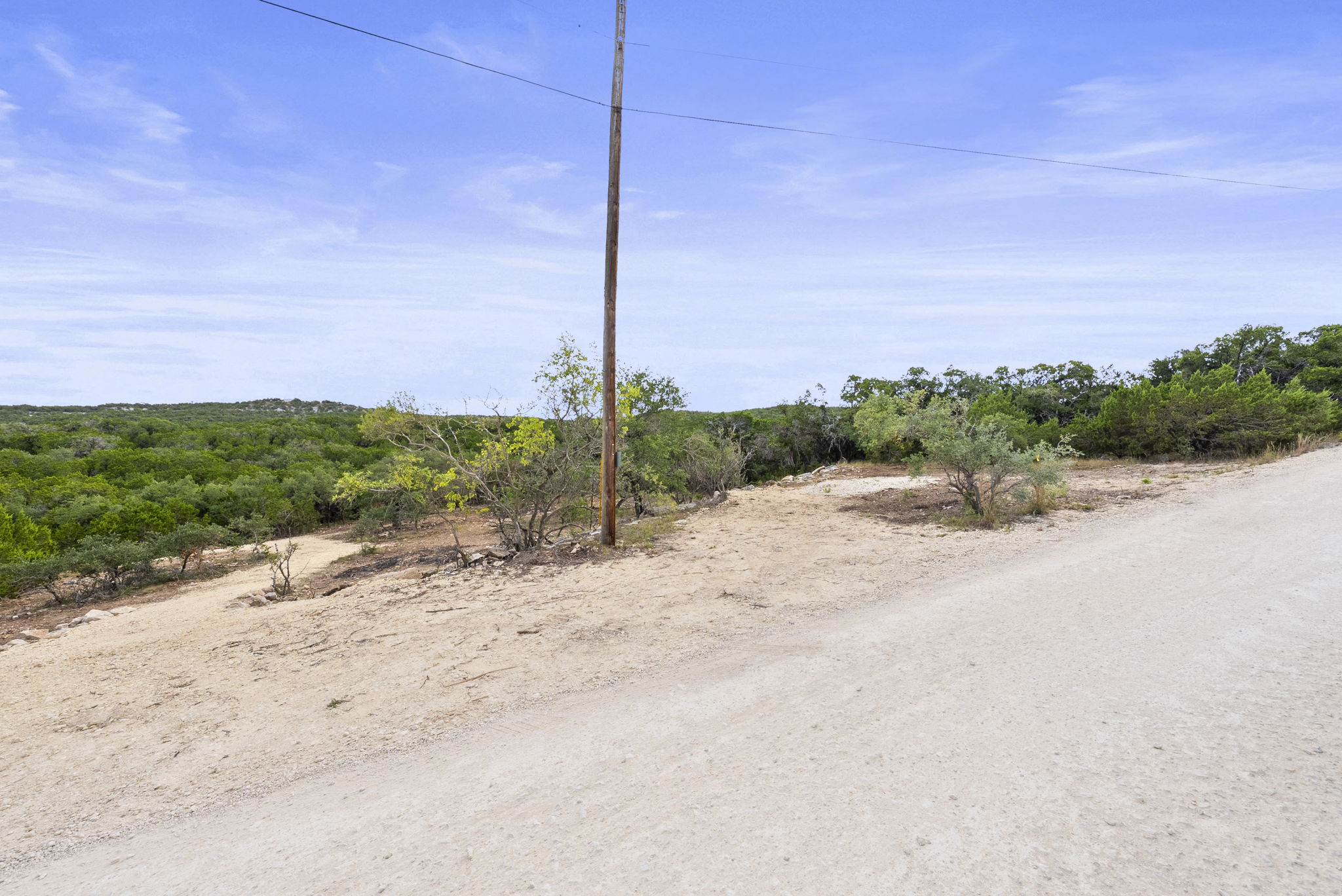 1250 Myers Creek Road Dripping Springs, TX 78620 - Photo 8 of 34 Recent improvements include a new cut entry drive, a wide clearing for a potential home site, and the removal of a natural dam in the dry creek bed.
