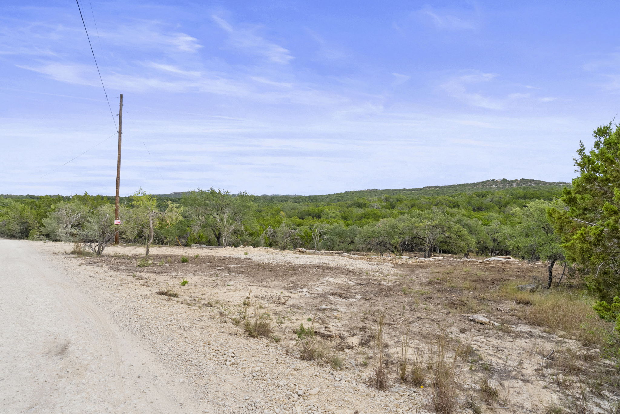 1250 Myers Creek Road Dripping Springs, TX 78620 - Photo 9 of 34 Recent improvements include a new cut entry drive, a wide clearing for a potential home site, and the removal of a natural dam in the dry creek bed.