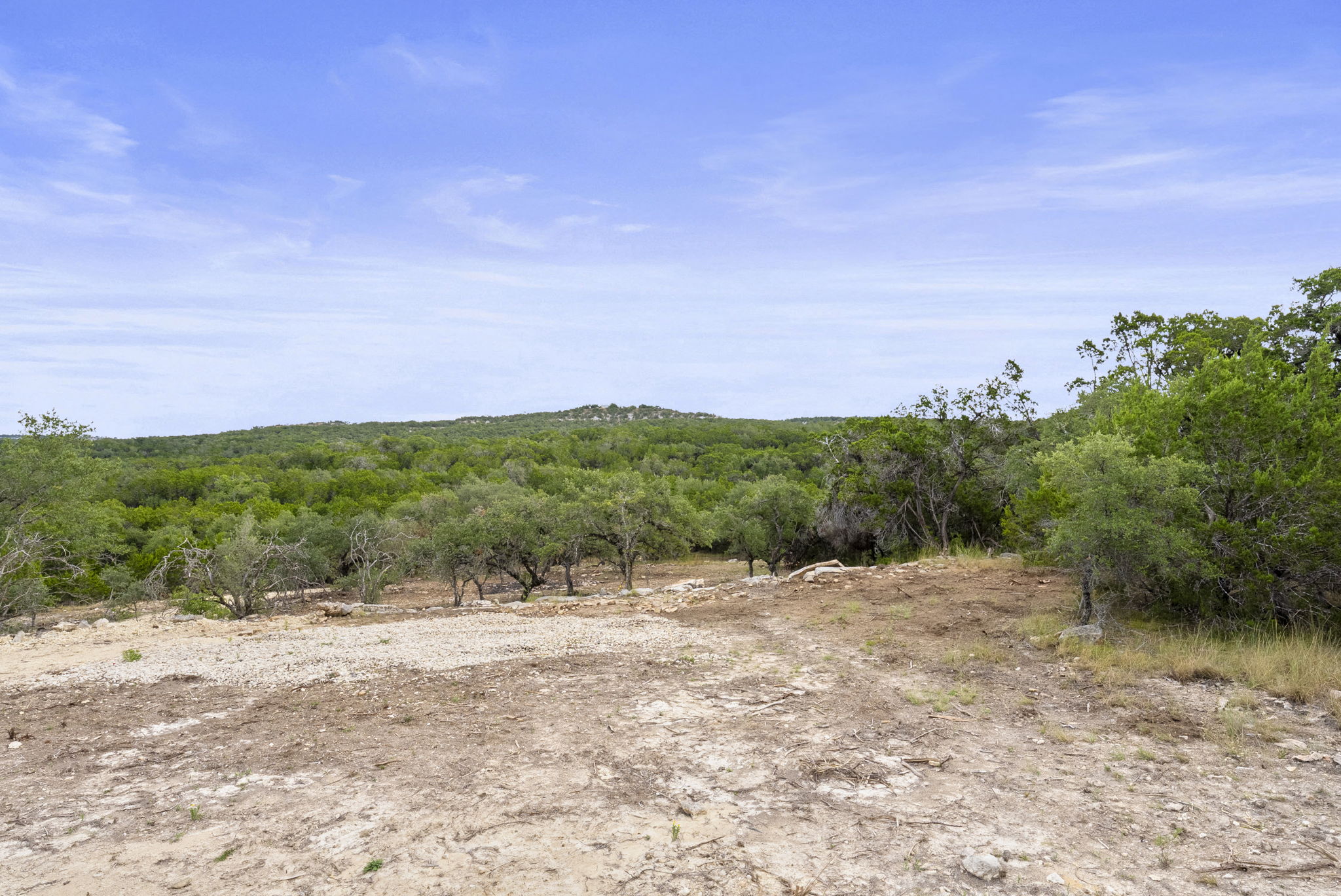 1250 Myers Creek Road Dripping Springs, TX 78620 - Photo 10 of 34 Recent improvements include a new cut entry drive, a wide clearing for a potential home site, and the removal of a natural dam in the dry creek bed.