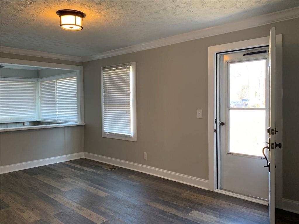 1261 Concord Road Southeast Smyrna, GA 30080 - Photo 4 of 50 an empty room with wooden floor and a window