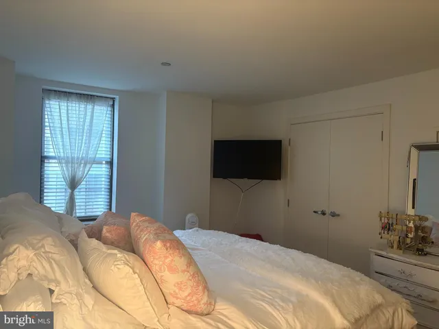 a bedroom with a bed and a television