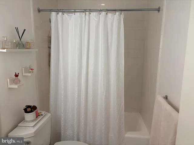 a bathroom with a shower curtain and a sink