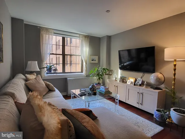 a bedroom with bed and a flat screen tv