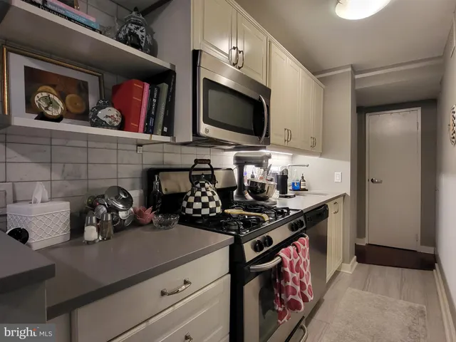 a kitchen with stainless steel appliances a stove and a microwave