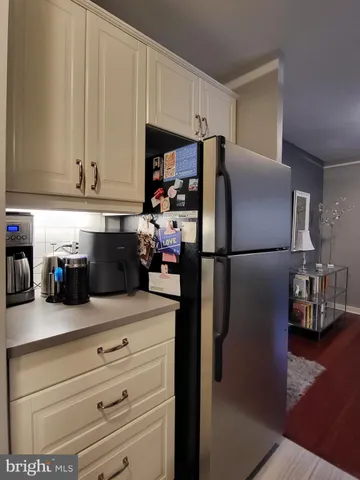 a kitchen with a refrigerator and cabinets