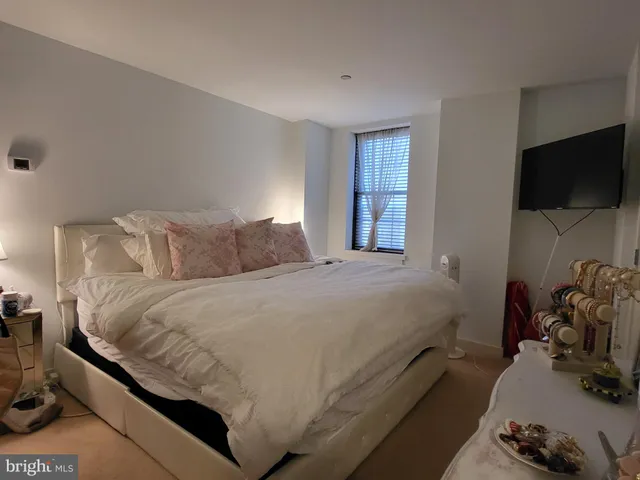 a bedroom with a bed and a flat screen tv