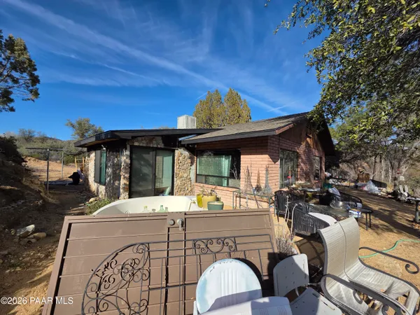 a view of a chairs and table in the patio