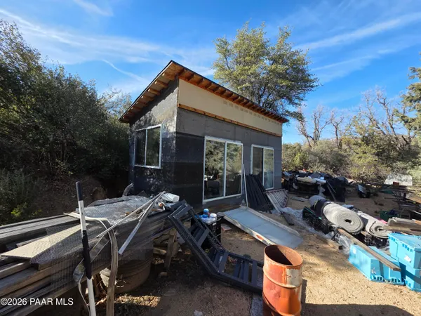 a view of backyard with outdoor seating and plants