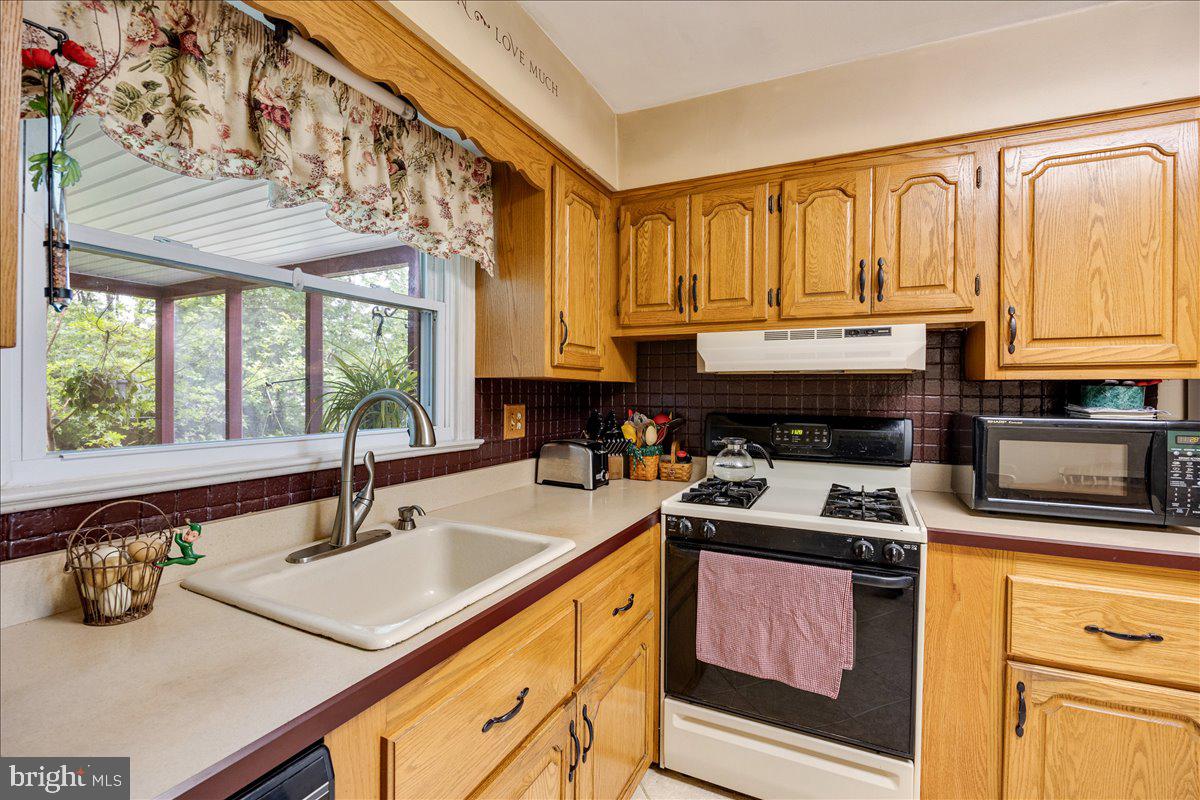 519 Bancroft Road Cherry Hill, NJ 08034 - Photo 15 of 28 a kitchen with a sink a stove and cabinets