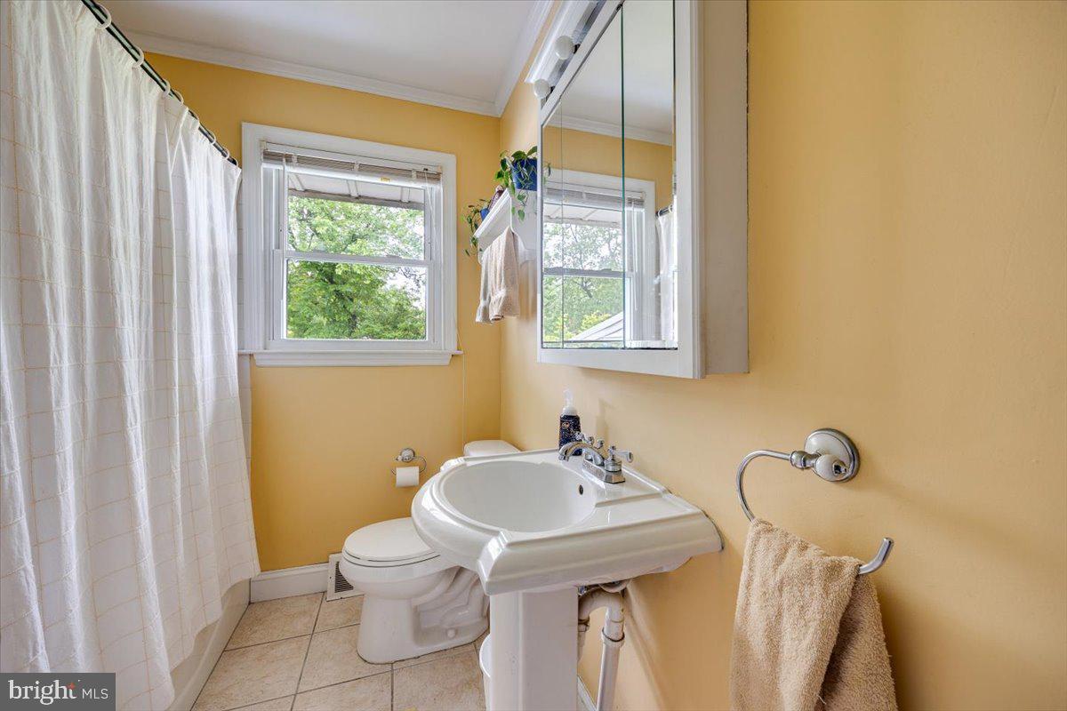 519 Bancroft Road Cherry Hill, NJ 08034 - Photo 24 of 28 a bathroom with a sink a toilet and a mirror