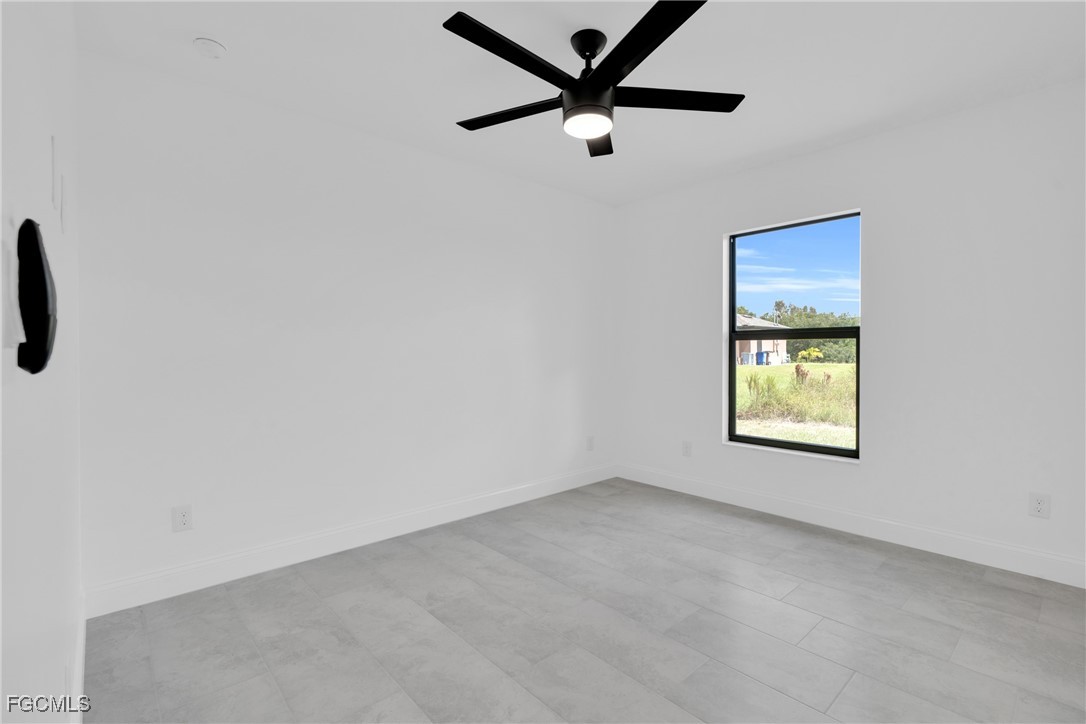 2510 Park Road Lehigh Acres, FL 33971 - Photo 12 of 37 an empty room with windows and fan