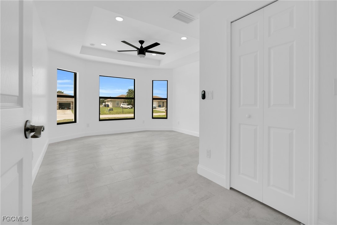 2510 Park Road Lehigh Acres, FL 33971 - Photo 13 of 37 a view of a livingroom with a ceiling fan & windows