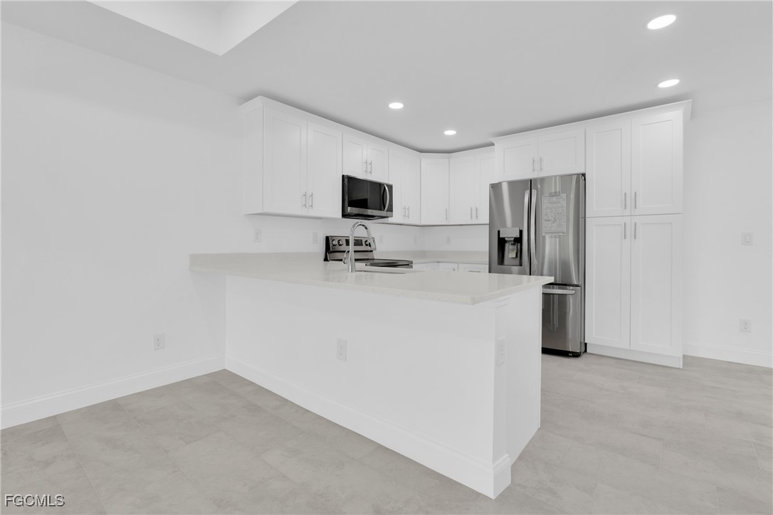 2510 Park Road Lehigh Acres, FL 33971 - Photo 16 of 37 a kitchen with refrigerator and a microwave