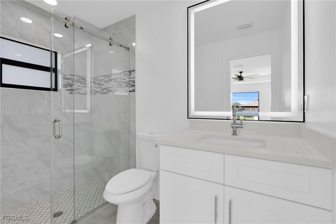 2510 Park Road Lehigh Acres, FL 33971 - Photo 20 of 37 a bathroom with a toilet sink and a mirror