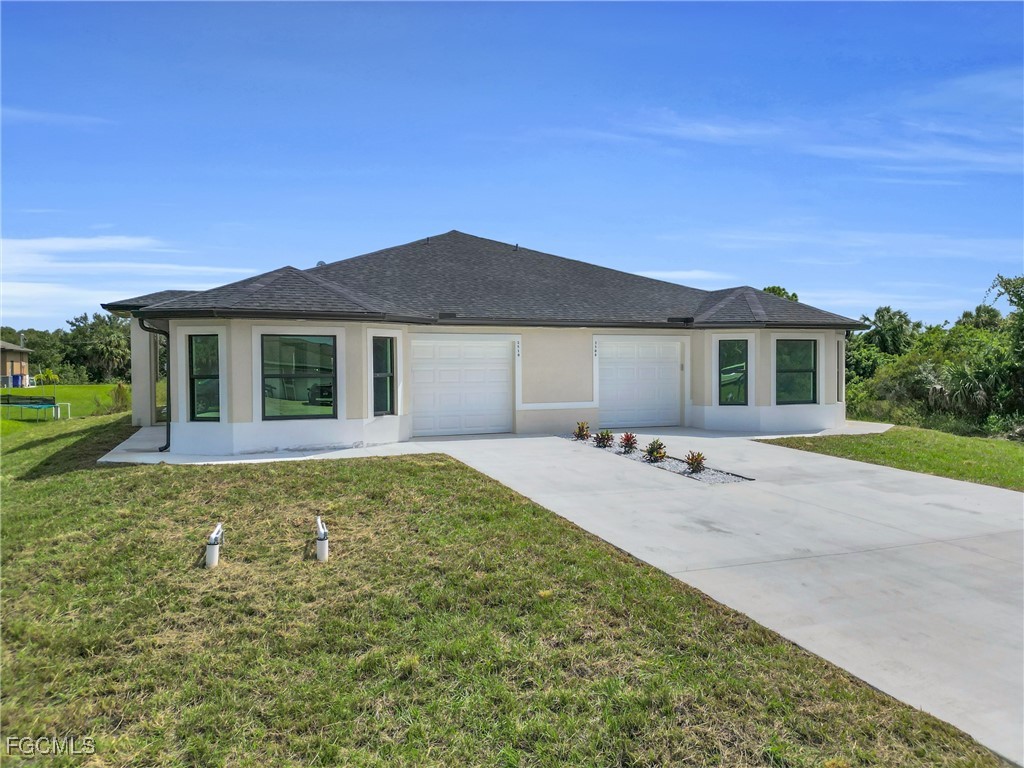 2510 Park Road Lehigh Acres, FL 33971 - Photo 2 of 37 a house view with a garden space
