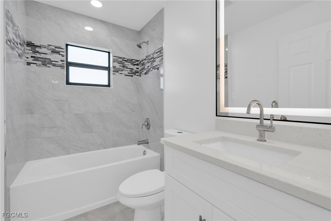 2510 Park Road Lehigh Acres, FL 33971 - Photo 22 of 37 a bathroom with a sink a toilet and a bathtub