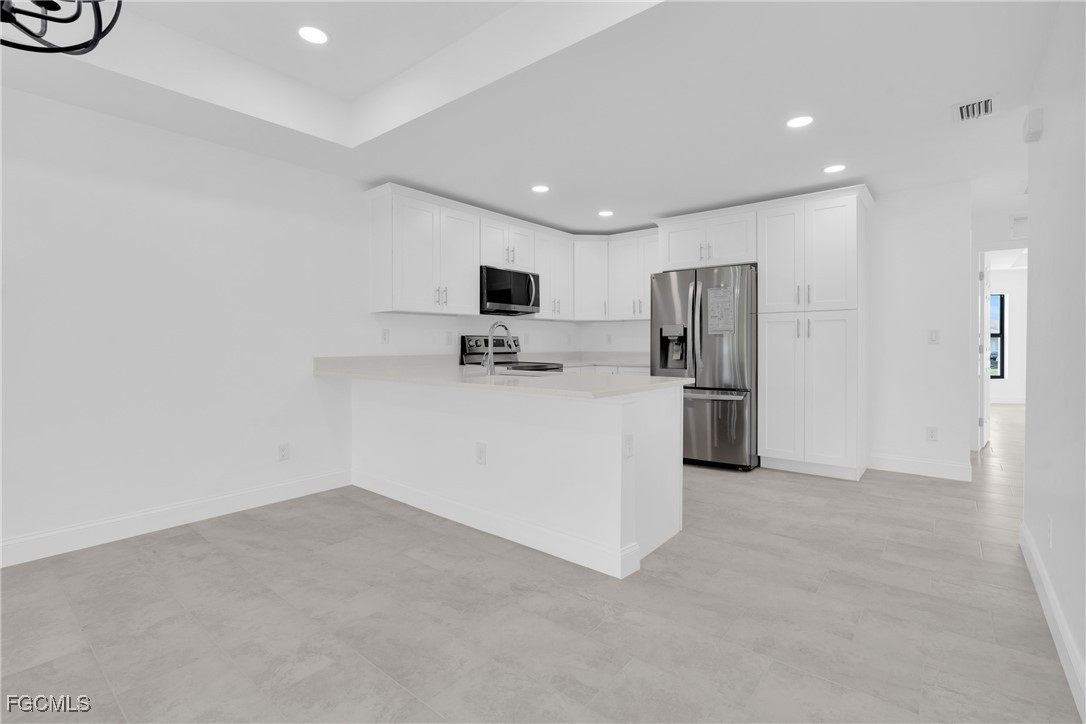 2510 Park Road Lehigh Acres, FL 33971 - Photo 10 of 37 a kitchen with a refrigerator and a sink