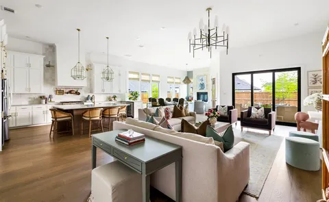 a living room with lots of furniture and a chandelier