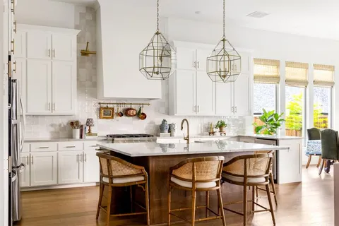 a kitchen with a table chairs sink and cabinets