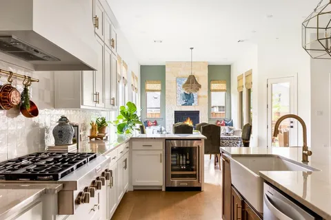 a kitchen with stove a sink and cabinets
