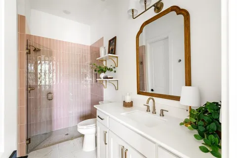 a bathroom with a sink a toilet and shower