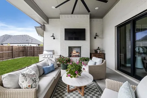 a living room with furniture a flat screen tv and a fireplace