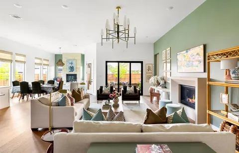 a living room with fireplace furniture and a chandelier