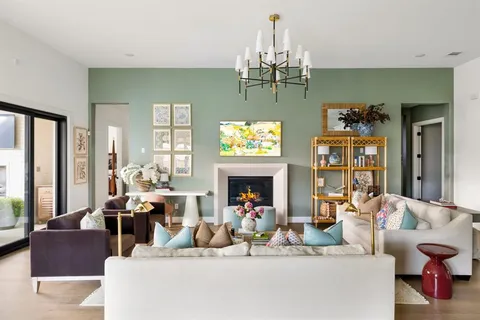 a living room with fireplace furniture and a chandelier