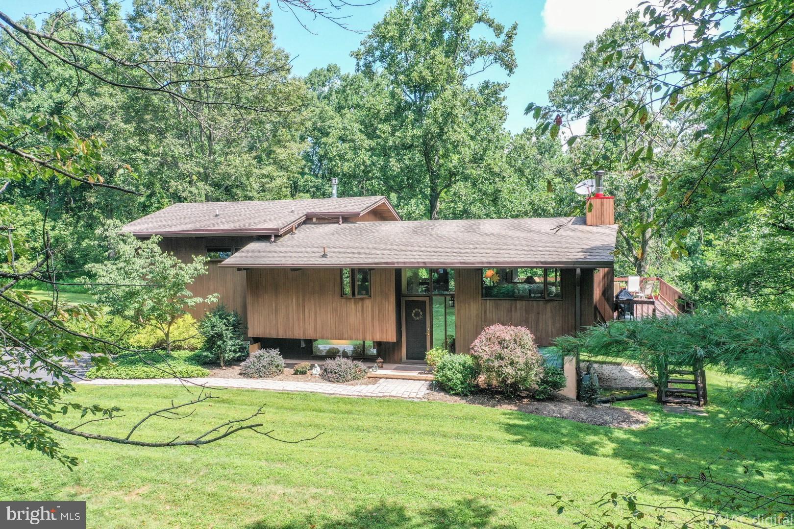 1708 Dahlgren Road Middletown, MD 21769 - Photo 1 of 60 a view of a white house with a big yard plants and large trees