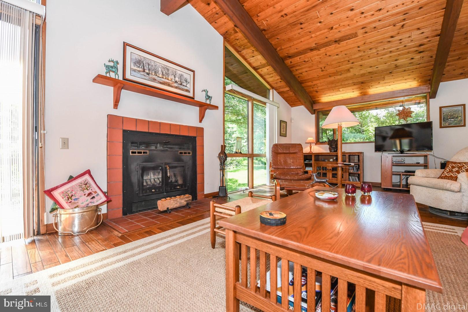 1708 Dahlgren Road Middletown, MD 21769 - Photo 6 of 60 a living room with furniture a fireplace and a floor to ceiling window