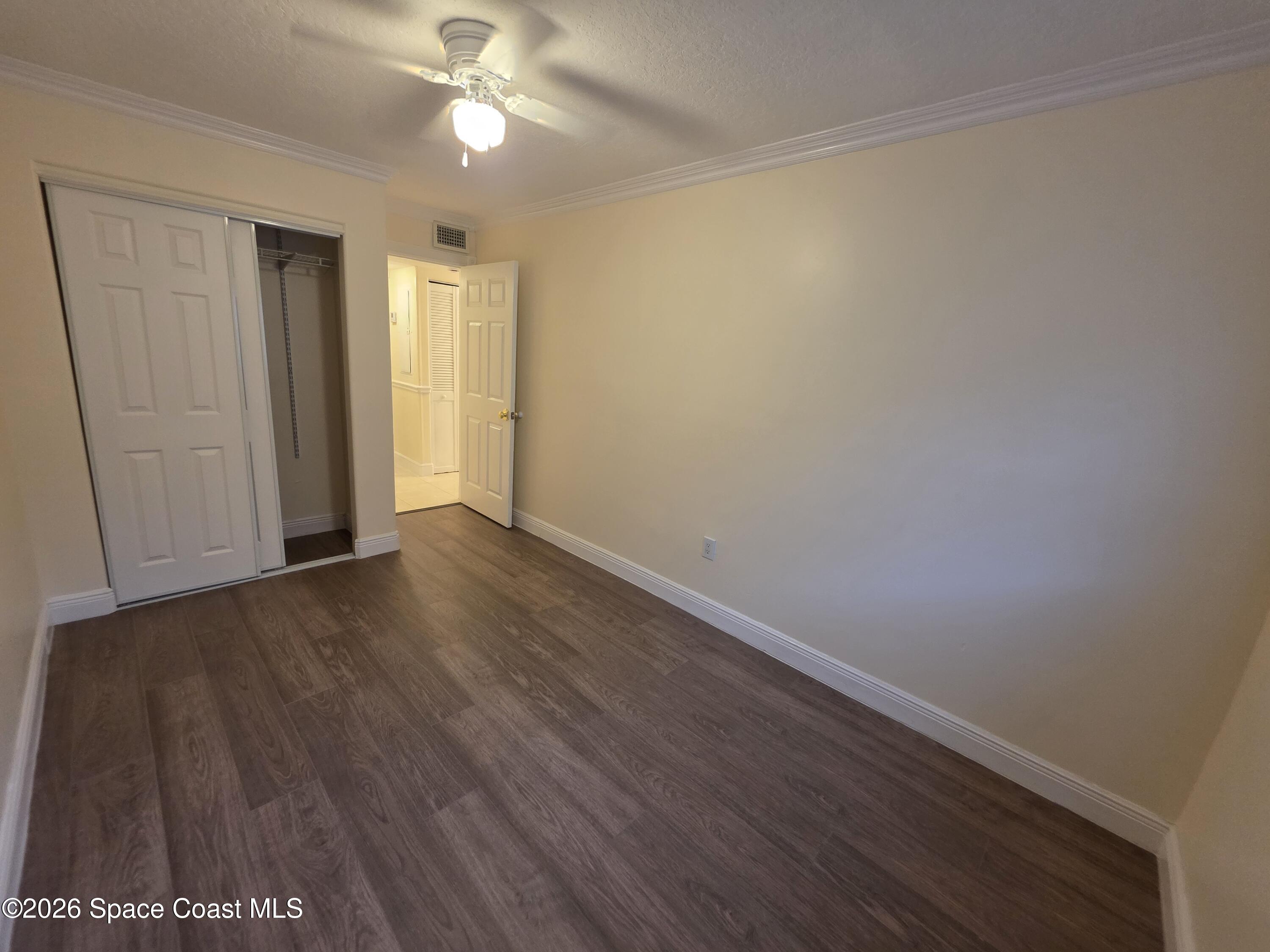 189 Cambridge Lane Melbourne, FL 32935 - Photo 12 of 14 a view of an empty room with wooden floor